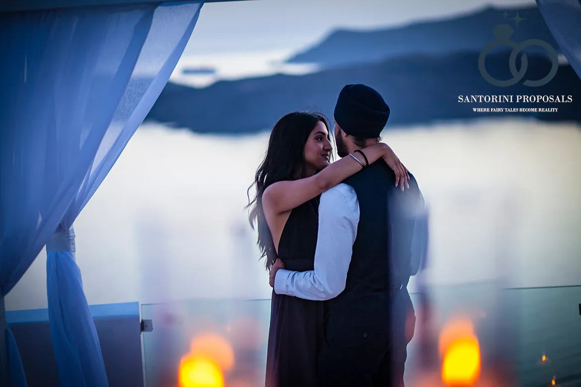 proposal in Oia with blue domes in the background