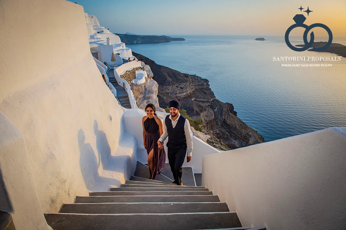 couple during a sunset proposal on the Santorini caldera cliffs