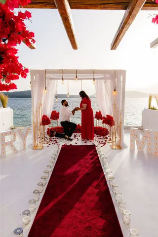 Santorini proposal red dress AION venue
