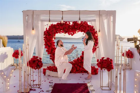 Santorini proposal red rose heart kneeling