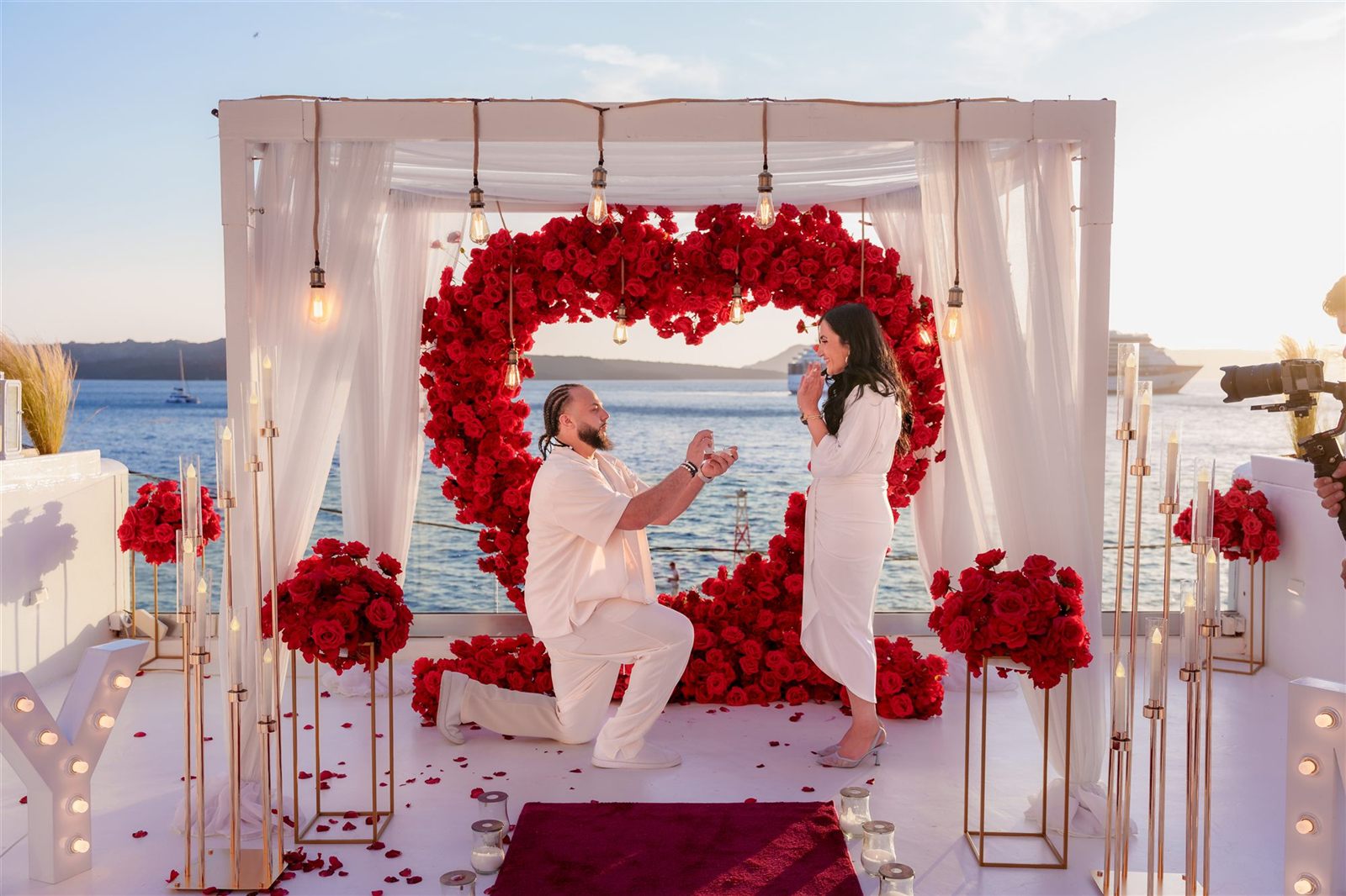 Santorini proposal red rose heart kneeling