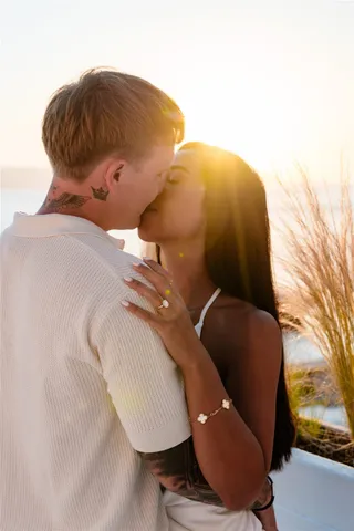 Santorini proposal sunset kiss backlit
