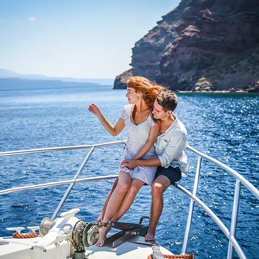 Sunset boat proposal on a private catamaran in Santorini