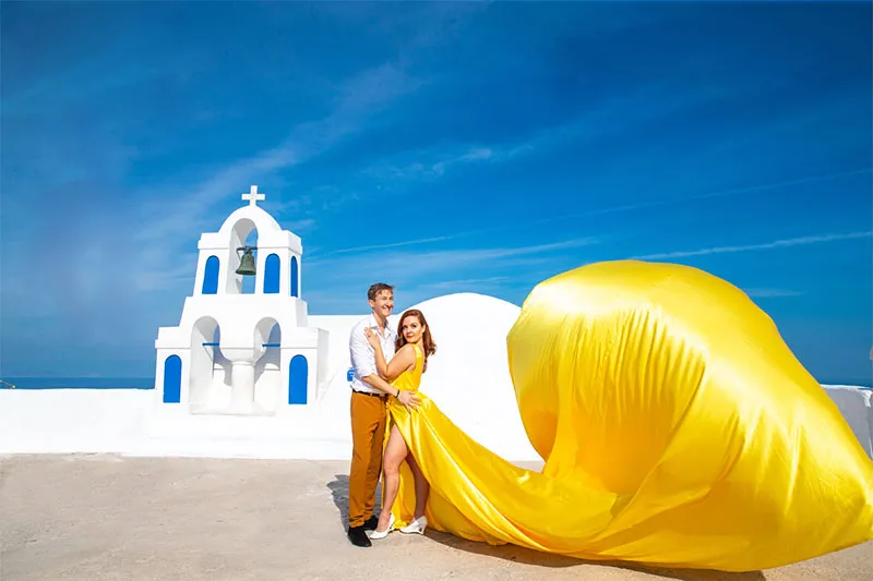 Oia proposal flying dress yellow